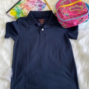 The brand is Cat and Jack. It’s a blue uniform polo for girls. The size is 6/7.